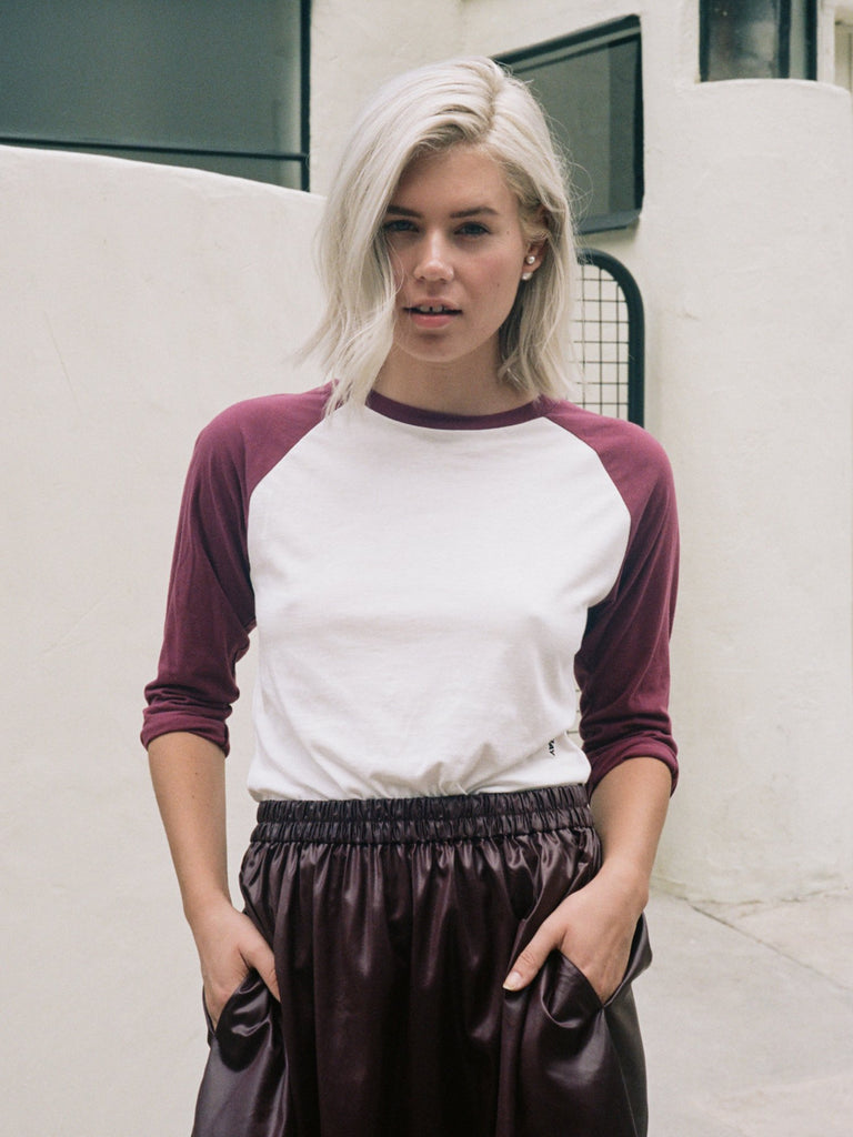 Blonde woman with two tone luxury raglan baseball tee in Rouge and White